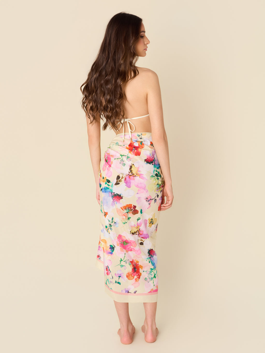 Cotton-silk pareo cover-up with soft watercolor flowers on a sun-kissed golden ground by GEM Beach Collection.